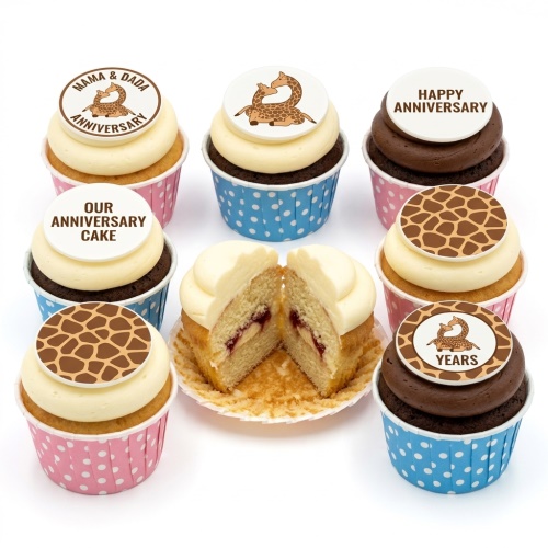 A selection of anniversary cupcakes with giraffe couple and print toppers, in pink and blue cases.