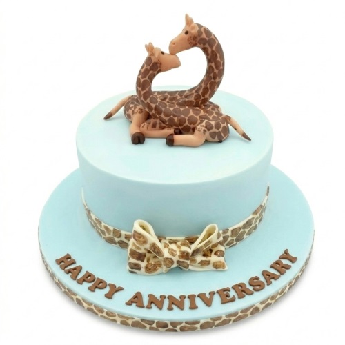 Two-tier light blue anniversary cake with two giraffe figures and giraffe print bow.