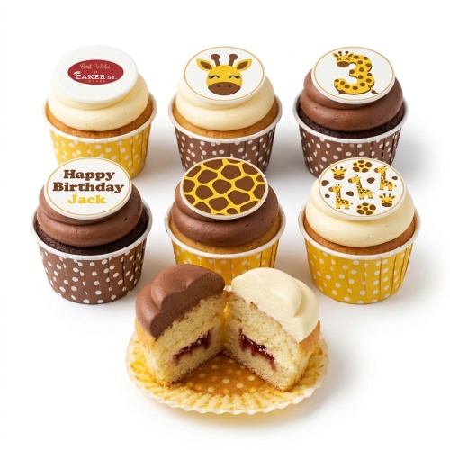 Assortment of giraffe-themed birthday cupcakes with custom age and personalised message toppers.