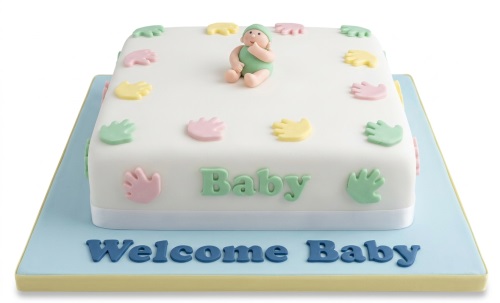 White square baby shower cake with pastel handprints, a baby figurine, and "Welcome Baby" text.