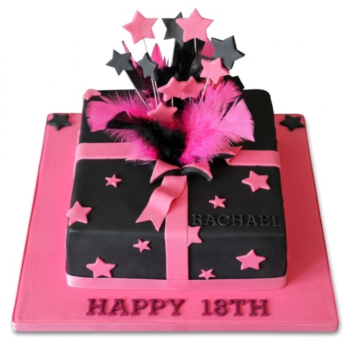 Pink and black gift box style birthday cake with stars and feathers, featuring a custom age message.