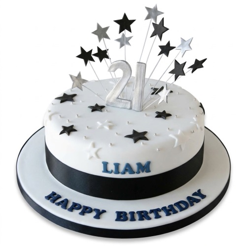 Round white birthday cake with black ribbon, silver and black star burst toppers, and a custom age number.