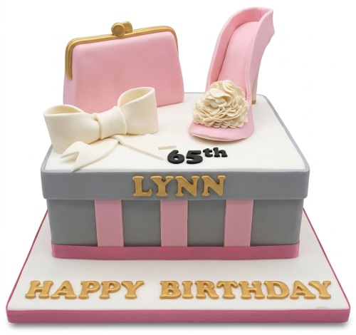 Square gift box style birthday cake with pink high heel shoe, handbag, white bow, and custom age topper.