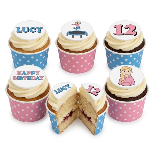 Birthday cupcakes with white frosting, polka dot wrappers, and custom toppers including a trampoline and a girl.