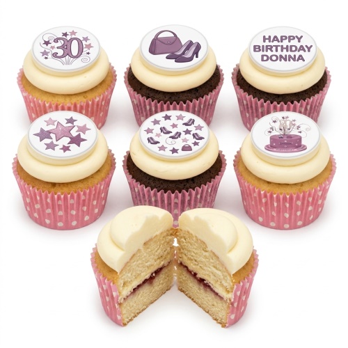 Six cupcakes with white frosting and pink wrappers, decorated with purple high heels, handbags, stars, a custom age topper, and a personalised birthday message.