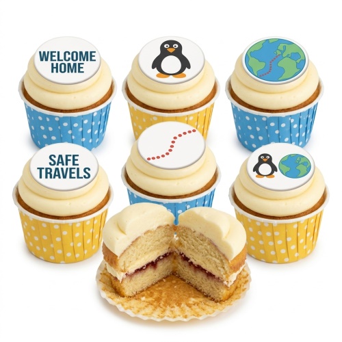 Cupcakes with white frosting and edible toppers featuring penguins, a globe with a travel path, and "WELCOME HOME" and "SAFE TRAVELS" messages.