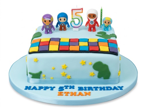 Square Go Jetters themed birthday cake with character figurines, colourful blocks, stars, and a custom age candle.