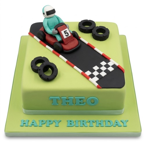 Two-tier green go-kart racing birthday cake with a driver, race track, and decorative tyres.