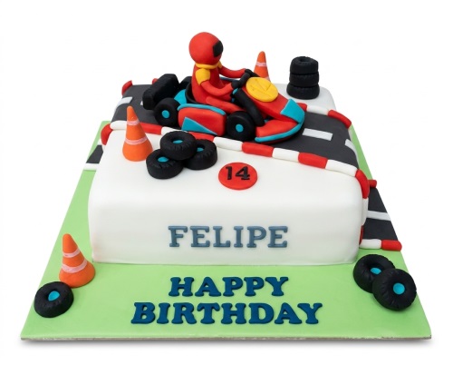 Rectangular white cake with a 3D red and blue go-kart, driver, racing track, orange cones, and black tyre decorations.