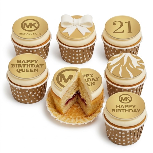 Gold and white designer-inspired birthday cupcakes with MK logo, bow, abstract pattern, and custom age topper.
