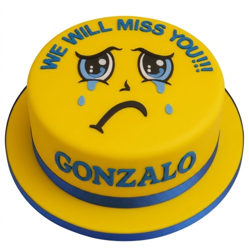 Round yellow cake with a crying emoji face on top, blue 'WE WILL MISS YOU!!!' text, and a blue ribbon with a personalised name.