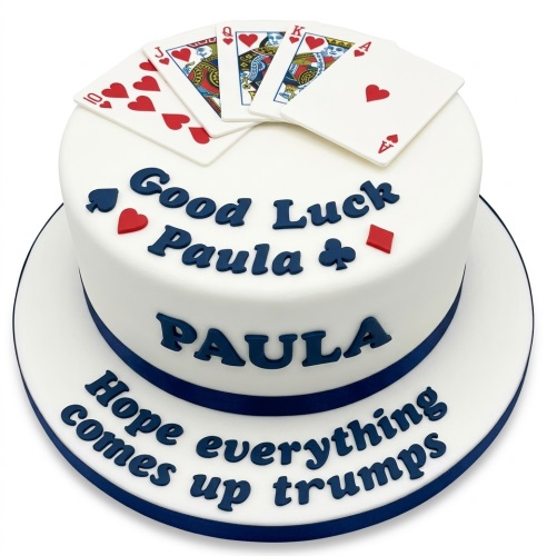 Round white cake decorated with edible playing cards, card suit symbols, and a custom message.