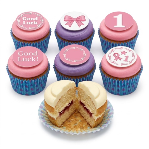 Pink and purple cupcakes with 'Good Luck!' messages, a bow, and a custom age '1' topper.