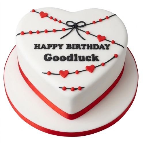 White heart-shaped birthday cake with red hearts, red beads, black lines, black bow, and a custom message.
