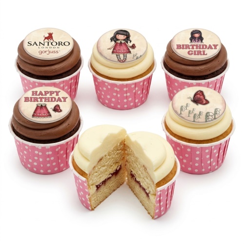 Six Gorjuss themed birthday cupcakes with doll and butterfly toppers in pink polka dot wrappers.