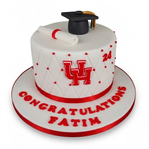 White graduation cake with red ribbon, cap, diploma, and customisable message.