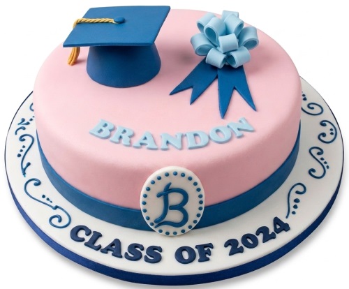 Pink graduation cake with blue graduation cap, ribbon, and custom name.