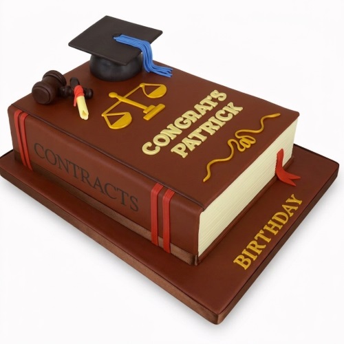 Brown law book cake with graduation cap, scales of justice, and diploma