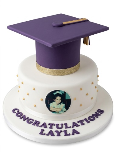 Two-tier white and purple graduation cake with custom photo and gold details.