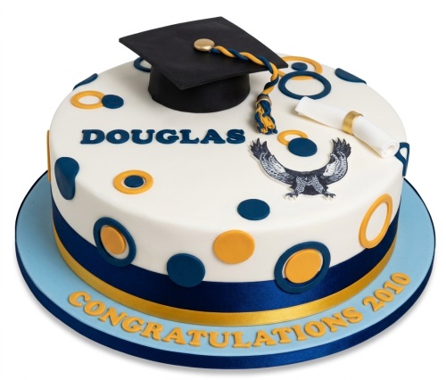 White graduation cake with blue and gold accents, featuring a mortarboard cap, diploma, and eagle emblem.