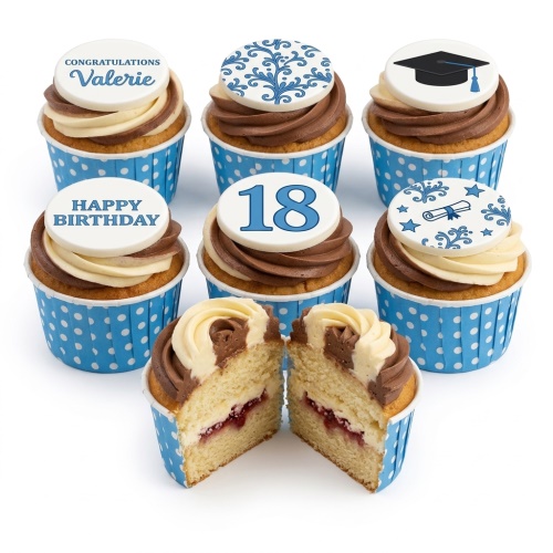 Blue and white celebration cupcakes with custom age, name, and graduation toppers.
