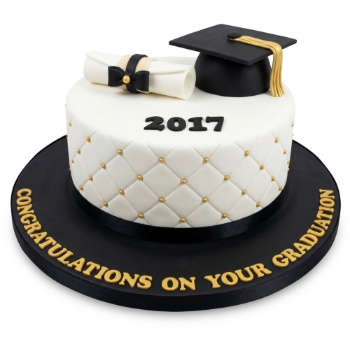 Elegant white graduation cake with black cap, diploma, gold pearls, and 'Congratulations on your Graduation' message.
