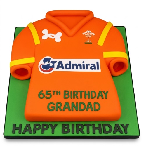 Orange rugby shirt shaped birthday cake on a green board with custom age and message.