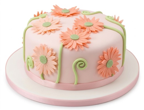 Round pink birthday cake with peach daisy flowers and green vines.