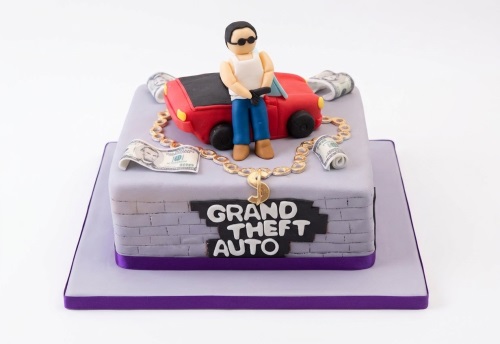 Grand Theft Auto theme birthday cake with character, red car, money, and GTA logo.
