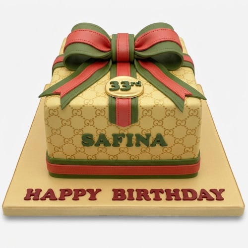 Designer gift box birthday cake with beige pattern, red and green bow, custom age topper, and personalised name.