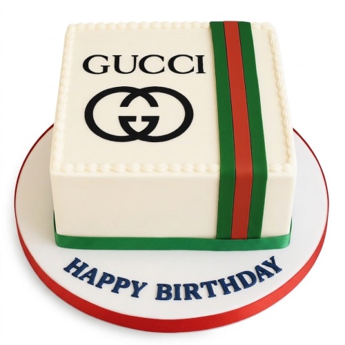 Square cream cake with black Gucci logo and red and green stripes, with 'Happy Birthday' on the board.