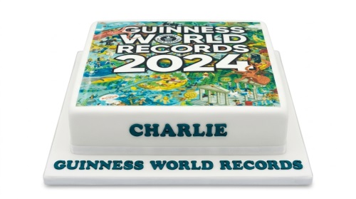 White square cake with Guinness World Records 2024 book cover edible image and custom name.