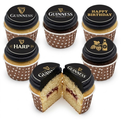Cupcakes with black frosting and edible toppers featuring Guinness, Harp, hops, beer bottle, and "Happy Birthday" text in polka dot wrappers.
