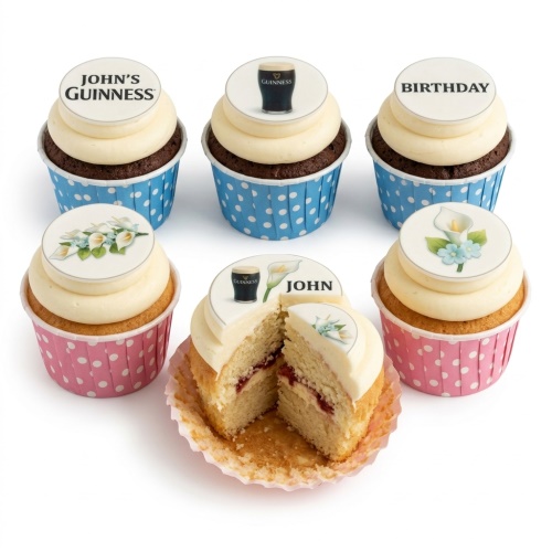 Selection of cupcakes with Guinness and floral toppers, some with 'Birthday' and 'John's Guinness' text, in blue and pink polka dot cases.