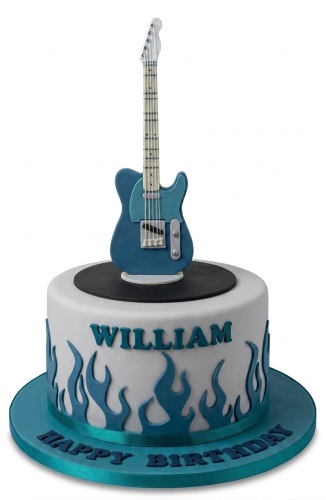 Round white birthday cake with blue electric guitar topper and blue flames, personalised message.