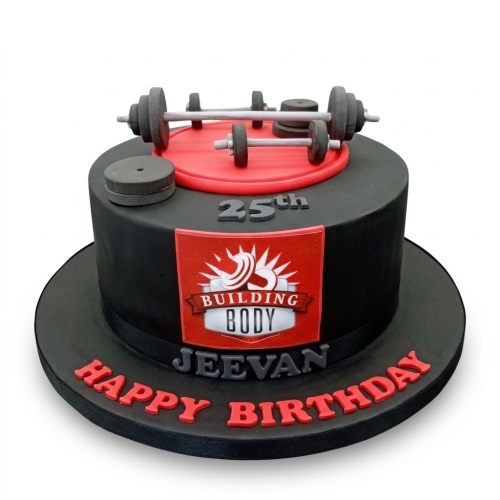 Black and red gym theme birthday cake with edible barbells, weight plates, and a custom age topper.
