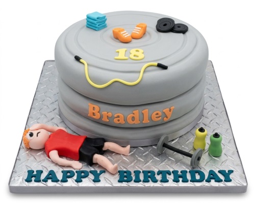 Grey gym theme birthday cake with weight plates, gym equipment, and custom age topper.