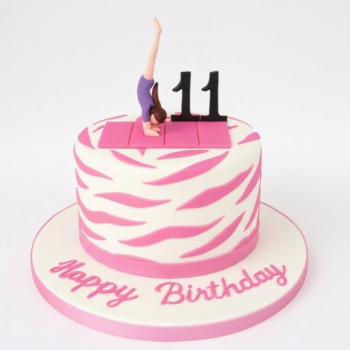 White and pink gymnastics themed birthday cake with a handstand figure and custom age topper.