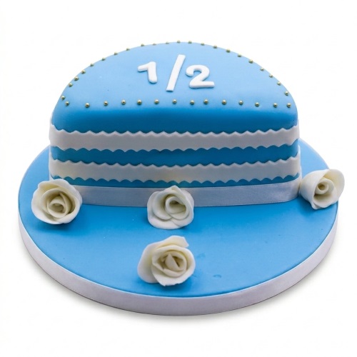 Blue semi-circle half birthday cake with white '1/2' topper, white wavy stripes, and white roses.