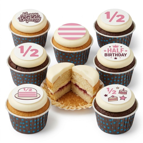 Assortment of half birthday cupcakes with pink and white 1/2 and Half Birthday toppers.
