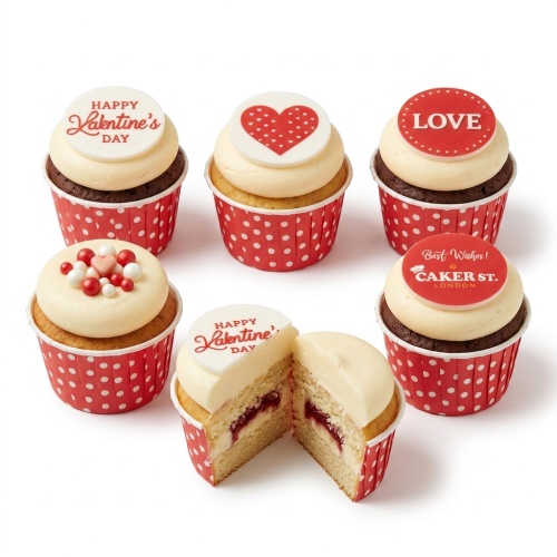 Valentines Day cupcakes with red hearts, 'LOVE' messages, and sprinkles in polka dot cases.