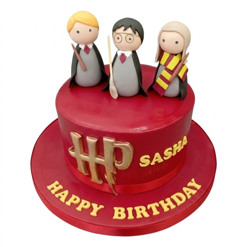 Red Harry Potter theme birthday cake with three wizard characters, HP logo, and custom message.