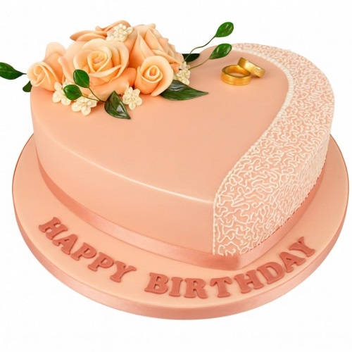 Heart-shaped peach cake with peach roses, green leaves, gold rings, and white lace pattern.