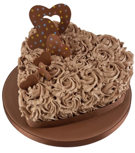 Heart-shaped cake with chocolate rosettes, brown ribbon, and chocolate heart decorations.
