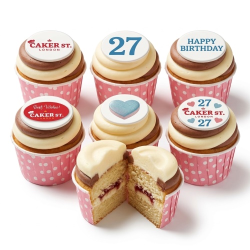 Vanilla and chocolate swirl cupcakes in pink polka dot cases with custom age and heart toppers.