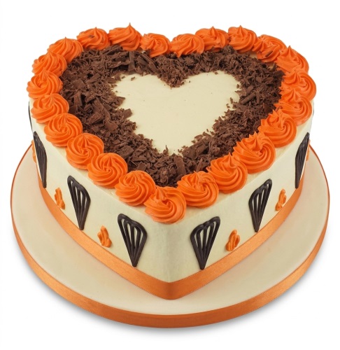 Heart-shaped cake with orange piped swirls, chocolate shavings, and an orange ribbon.