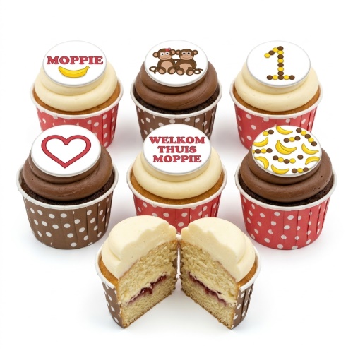 Set of baby shower cupcakes with monkey, banana, heart, and custom message toppers on vanilla and chocolate frosting.