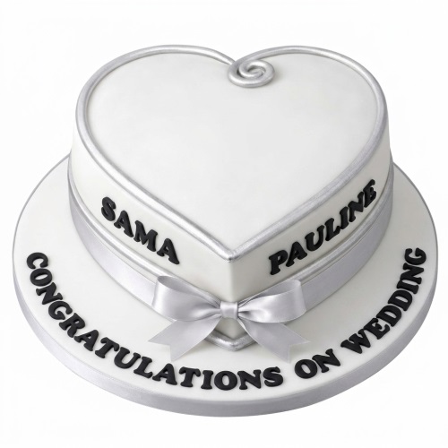 White heart shaped wedding cake with silver trim, ribbon, and personalised names.