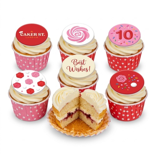 Assortment of vanilla cupcakes with white buttercream, featuring floral rose toppers, sprinkle designs, a custom age topper, and a 'Best Wishes' message, in pink and red polka dot wrappers.