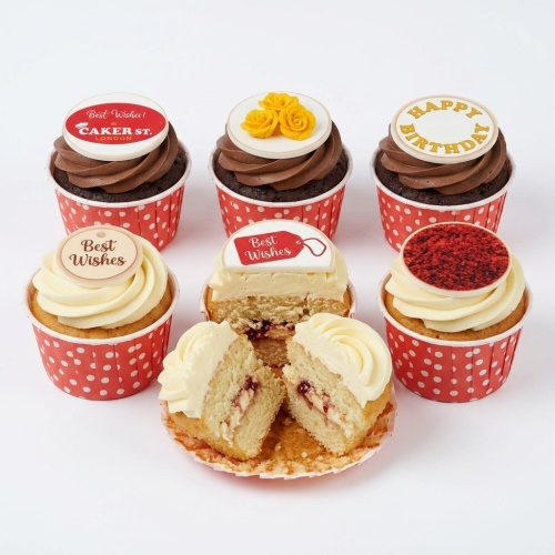 Assorted birthday and celebration cupcakes with chocolate and vanilla icing, yellow roses, and "Happy Birthday" toppers.